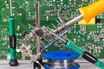 electrical board with a soldering iron and screwdrivers