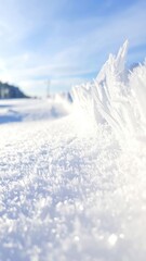 Obraz premium Close-up of frost formations on snow under a bright blue sky.