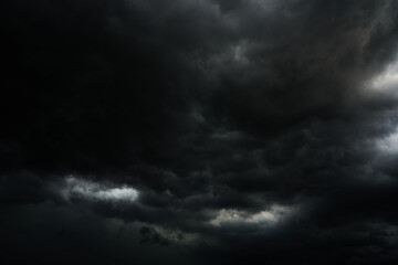 Obraz premium Dark Clouds rain storm and sun beam in storm. Dramatic sky background