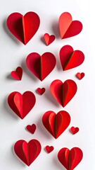 A vibrant display of three-dimensional red paper hearts scattered across a clean white background.