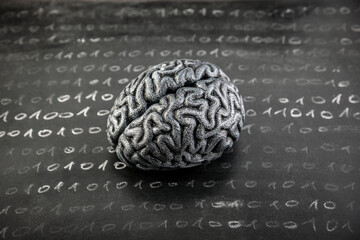 Naklejka premium Human brain model and binary code drawn with chalk on worn scholl blackboard. Science, learning or data loss concept.