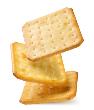 Square crackers falling close-up on a white. Isolated