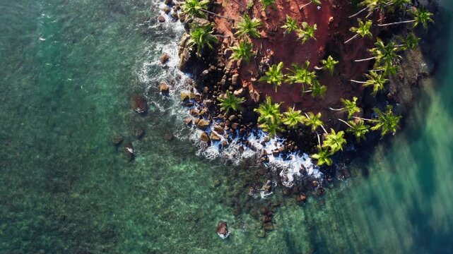 Famous Coconut Tree Hill aerial top view 4K video is a beautiful Nature's landmark in Mirissa, Matara District on Sri Lanka. Exotic Asian countries and around the World traveling concept.