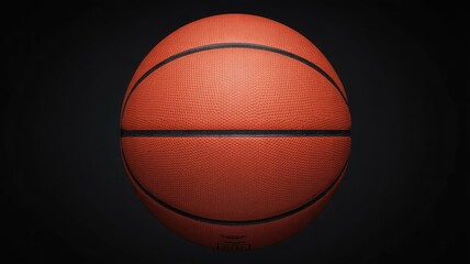 Obraz premium A close-up, well-lit shot of a classic orange basketball against a dark, minimalist background, highlighting its texture and seams.