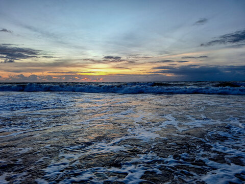 Ocean Waves Under Colorful Sunset Sky