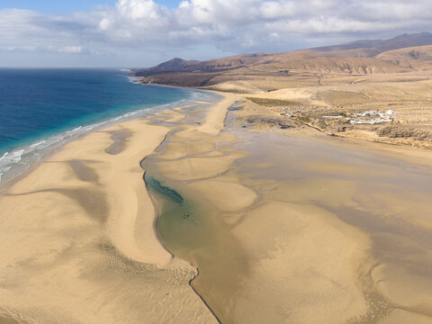 Aerial view of the meeting of turquoise waters and golden sands, where the coastline meets the arid landscape, Jand&Atilde;&shy;a Natural Park, Fuerteventura, Canary Islands, Spain.