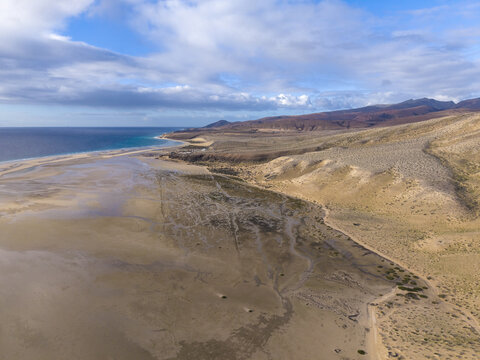 Aerial view of the stark contrast between the golden dunes and the turquoise sea, Jand&Atilde;&shy;a Natural Park, Fuerteventure, Canary Islands, Spain.
