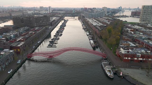 Aerial view of Amsterdam-Oost, The Netherlands, at dusk, red bridge between Sporenburg and Borneo neighbourhoods

