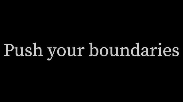 Inspirational white text reading 'Push your boundaries' centered against a solid black background provides motivation for personal development and goal achievement.