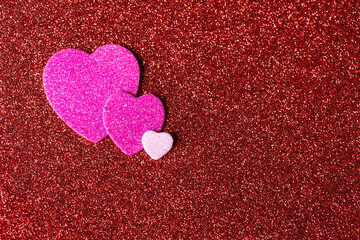 Valentine's Day, the Day of Love. Three hearts symbolizing a family. Happy parents with their beloved child. Copy space