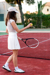 Obraz premium Young woman preparing to serve during tennis game