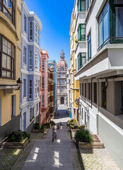 Fototapeta premium Narrow Street View Towards the Eclectic 1917 City Hall Dome in Maria Pita Square, A Coruña, Spain