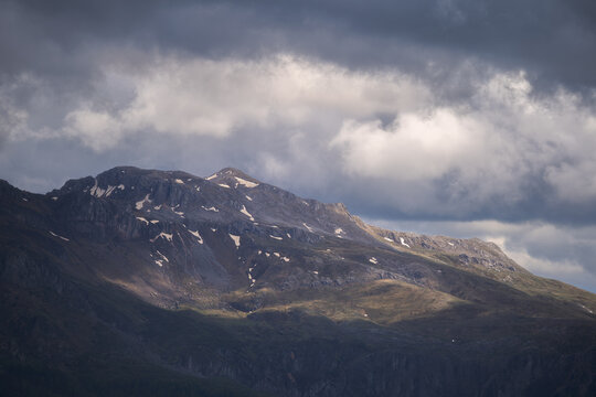 Aerial view of dramatic light casting shadows across the rugged mountain range of Lukomir under a stormy sky, Lukomir, Federation of Bosnia and Herzegovina, Bosnia and Herzegovina.