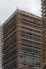 High Rise Skyscraper Under Renovation in Berlin Germany Wrapped in Extensive Metal Scaffolding Urban Construction Architecture