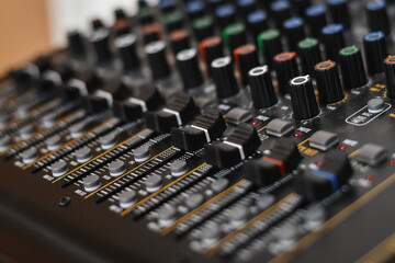Fototapeta premium Buttons of professsional music audio sound mixer. Low DOF, selective focus.