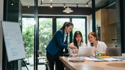 Female leader guiding new staff member at office with career advice and skill development discussion