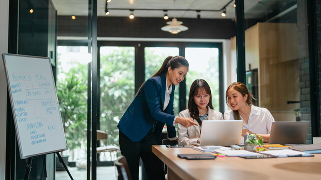 Female leader guiding new staff member at office with career advice and skill development discussion