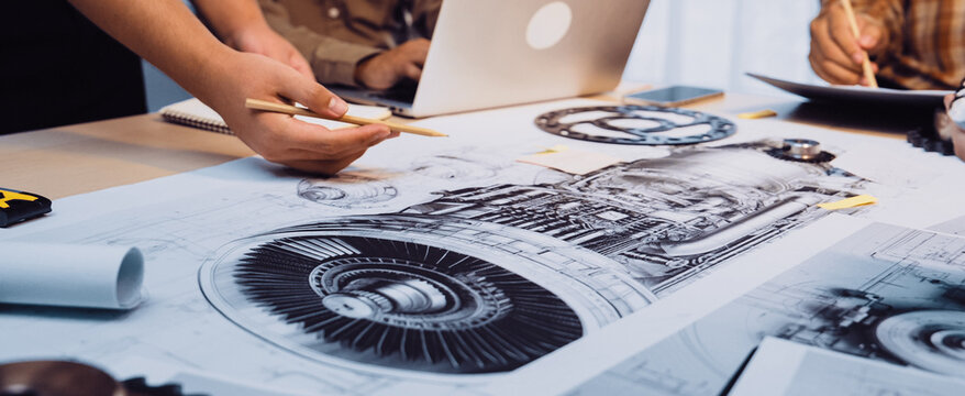A dynamic scene of engineers collaborating on a jet engine design, displaying technical drawings and using a laptop, showcasing teamwork in a modern office environment. SACTR