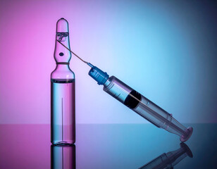liquid in a transparent vial and medical syringe. and needle