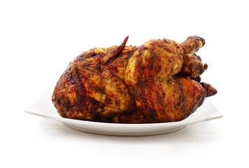 Roasted whole chicken on a white plate.