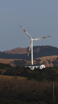Jeju Island, Jeju-Do, South Korea,  Sinchang Windmill Coastal Road landscape, line of wind mills power generators along the coast, offshore wind farm energy turbines, aerial drone view, green energy