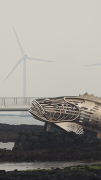 Jeju Island, Jeju-Do, South Korea,  Sinchang Windmill Coastal Road landscape, line of wind mills power generators along the coast, offshore wind farm energy turbines, aerial drone view, green energy