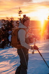 Fototapeta premium Mountaineer backcountry ski walking ski alpinist in the mountains. Ski touring in alpine landscape with snowy trees. Adventure winter sport. Low Tatras, slovakia