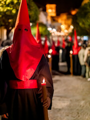 Nazareno holding a lit candle during holy week procession