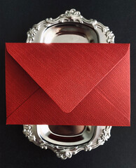 Red envelope on a silver tray