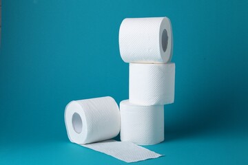 Obraz premium Rolls of toilet paper on light blue background