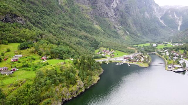 Top view of the village of Gudvangen from N&aelig;r&oslash;yfjord in Vestland county with mountain landscape with lush vegetation and farms in the valley
