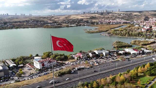 Rear view of the large Turkish flag waving over the lake shore