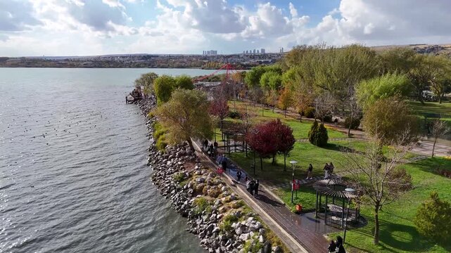Smooth side-tracking drone shot along the coastline of Mogan Park