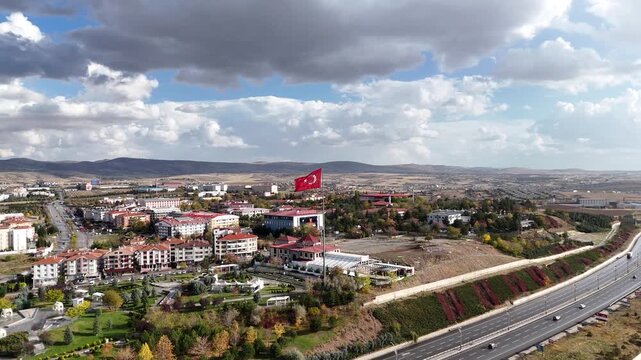 Steady aerial view of the national Turkish flag waving proudly at the lakeside park in Ankara