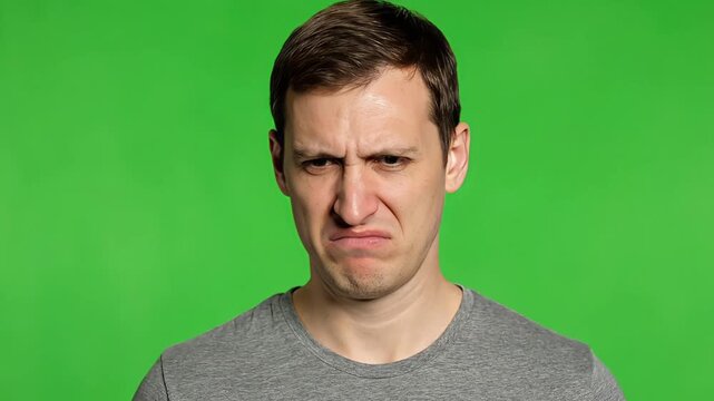 Man with concerned expression on green screen background