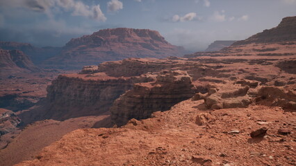 Stunning red rock formations rise dramatically against a clear sky, illuminated by the warm afternoon sun. The expansive landscape invites exploration and adventure amidst natures beauty. © icetray