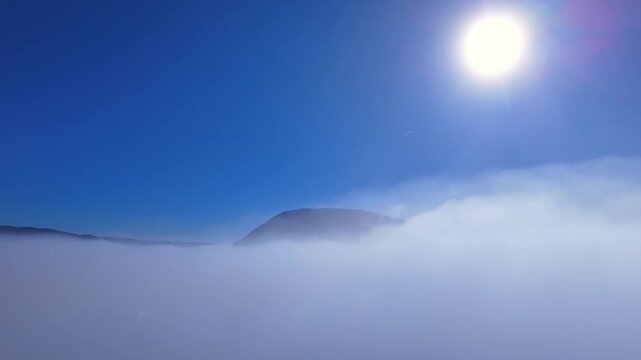 The drone descends into the fog. 