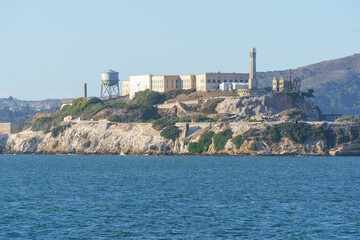 Daytime view of Alcatraz Island, showcasing the historic prison and surrounding waters in clear daylight. Iconic landmark in San Francisco Bay, popular for sightseeing, photography, and tourism