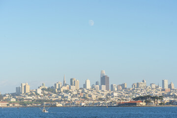 View of San Francisco from a tour boat in the middle of the bay, capturing the city skyline, waterfront, and iconic landmarks. Scenic perspective from the water, ideal for travel, tourism, and maritim