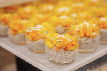 Assorted sweet pastries arranged on a serving tray, featuring a variety of desserts with creamy fillings and decorative toppings. Delicious baked treats presented for dessert, celebration, or caf&eacute; dis