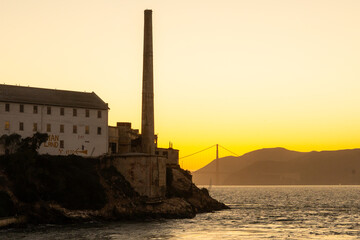 Alcatraz prison at sunset, showcasing the historic island fortress with dramatic evening lighting. Iconic landmark in San Francisco Bay, representing history, tourism, and a mysterious atmosphere