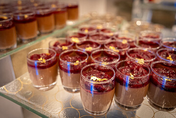 Assorted sweet pastries arranged on a serving tray, featuring a variety of desserts with creamy fillings and decorative toppings. Delicious baked treats presented for dessert, celebration, or caf&eacute; dis
