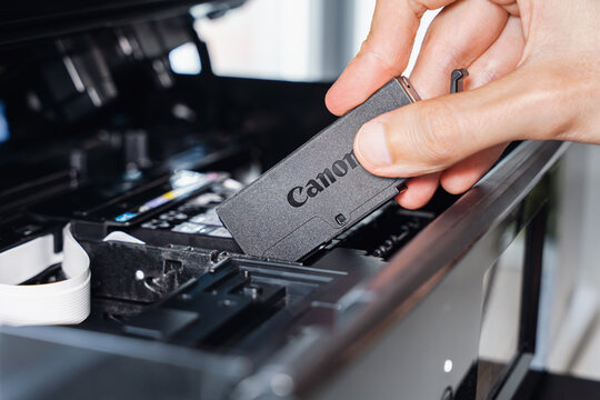 Hand Installing Black Ink Cartridge In Printer