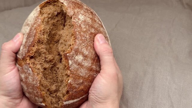 Close-up of a round loaf of dark wholegrain bread, showing detailed crust texture and rustic appearance. Perfect for bakery, food, and artisanal photography