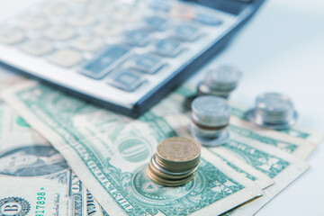 Fototapeta premium calculator and coins on the table, business concept of saving money