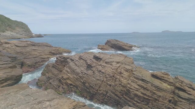 Rocks and waves in Buzios' Ferradurinha Beach in Rio de Janeiro State, Brazil
