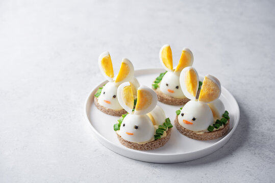 Bread with mayonnaise sauce and boiled egg in the form of rabbit in a plate for Easter holidays