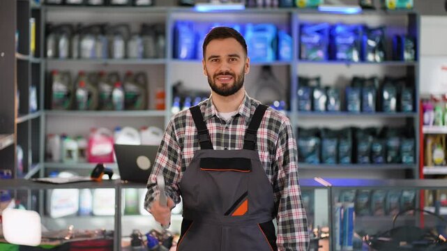 Mechanic posing with wrenches in auto parts store