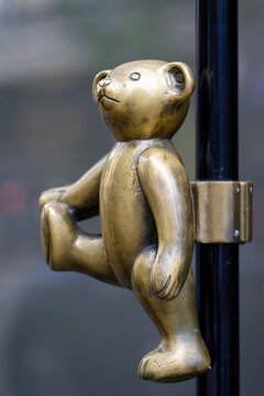 Cologne, Germany July 07 2024: Artistic side profile of the famous brass teddy bear door handle at the Steiff flagship store in Cologne, Germany. High-quality metal craftsmanship
