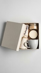 Fototapeta premium Gift box with candle, mug, and decorative items on white background 